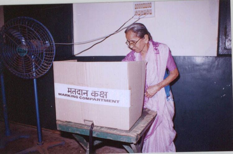 A voter at a screened marking compartment