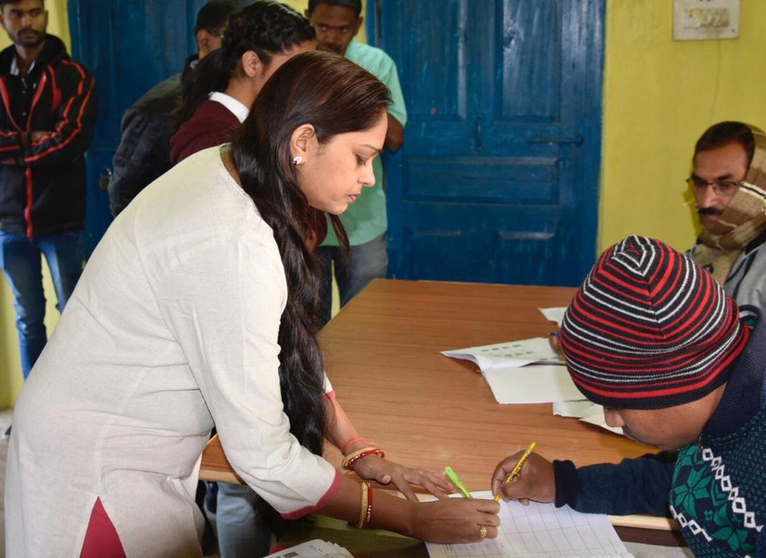A voter signing the register at a polling table